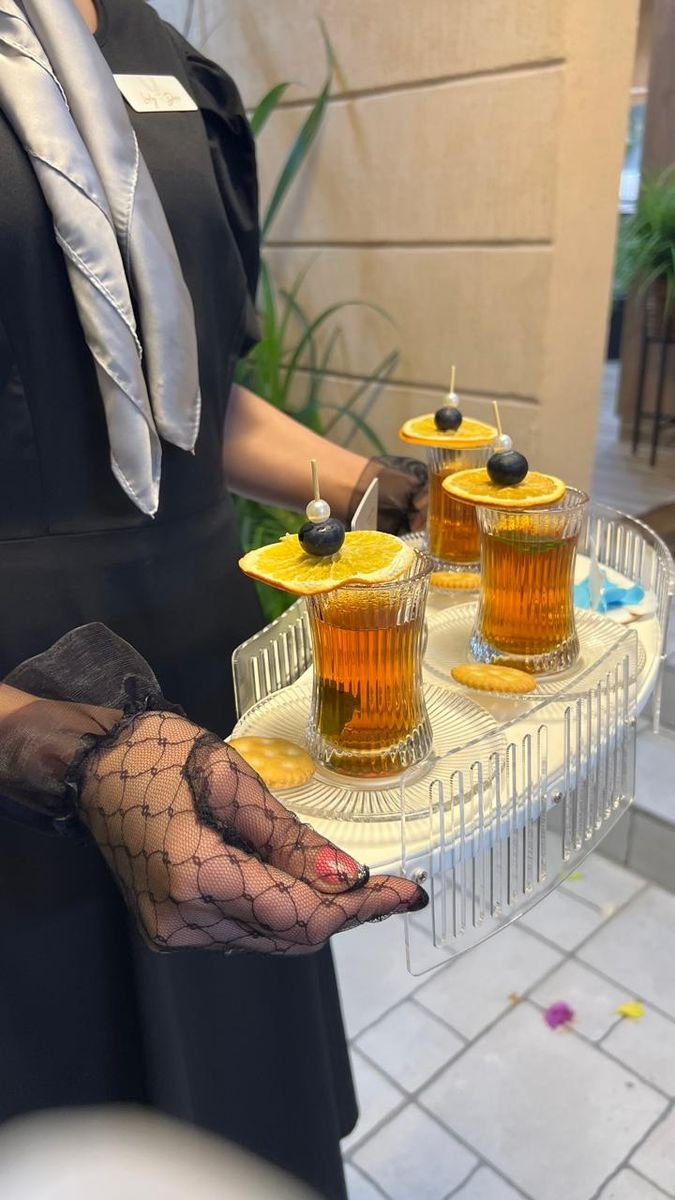 Tea served in crystal glasses with dried orange and pearls
